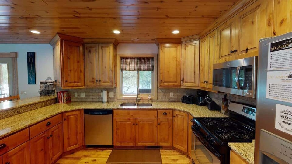 Full size kitchen with modern appliances, pots and pans, dishes, utensils, and basic cooking essentials.