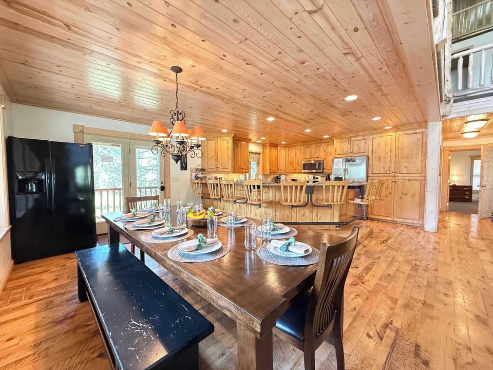 Dining table with extra fridge looking into the kitchen.