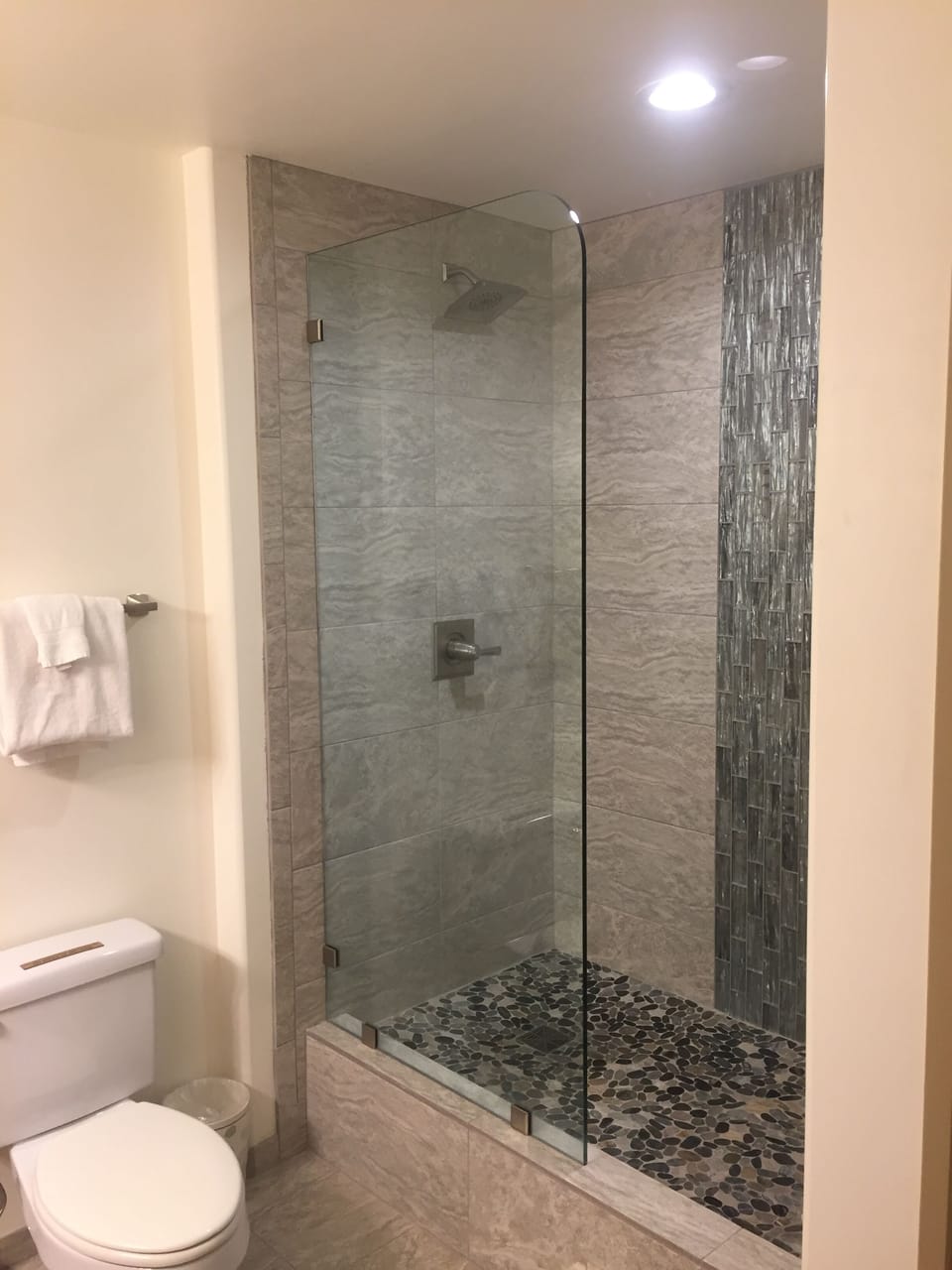 Shower with waterfall glass tiles