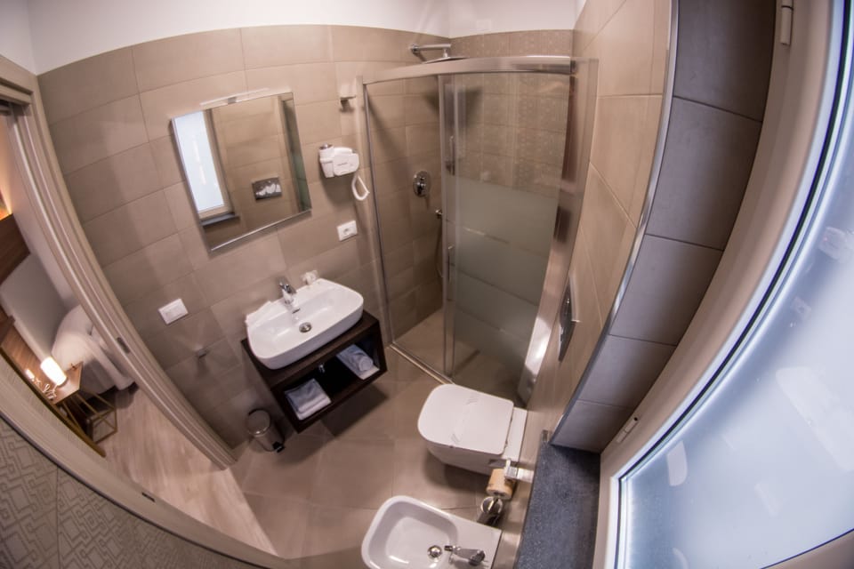 Single Room, 1 single bed, private bath | Bathroom | Shower, free toiletries, hair dryer, bathrobes