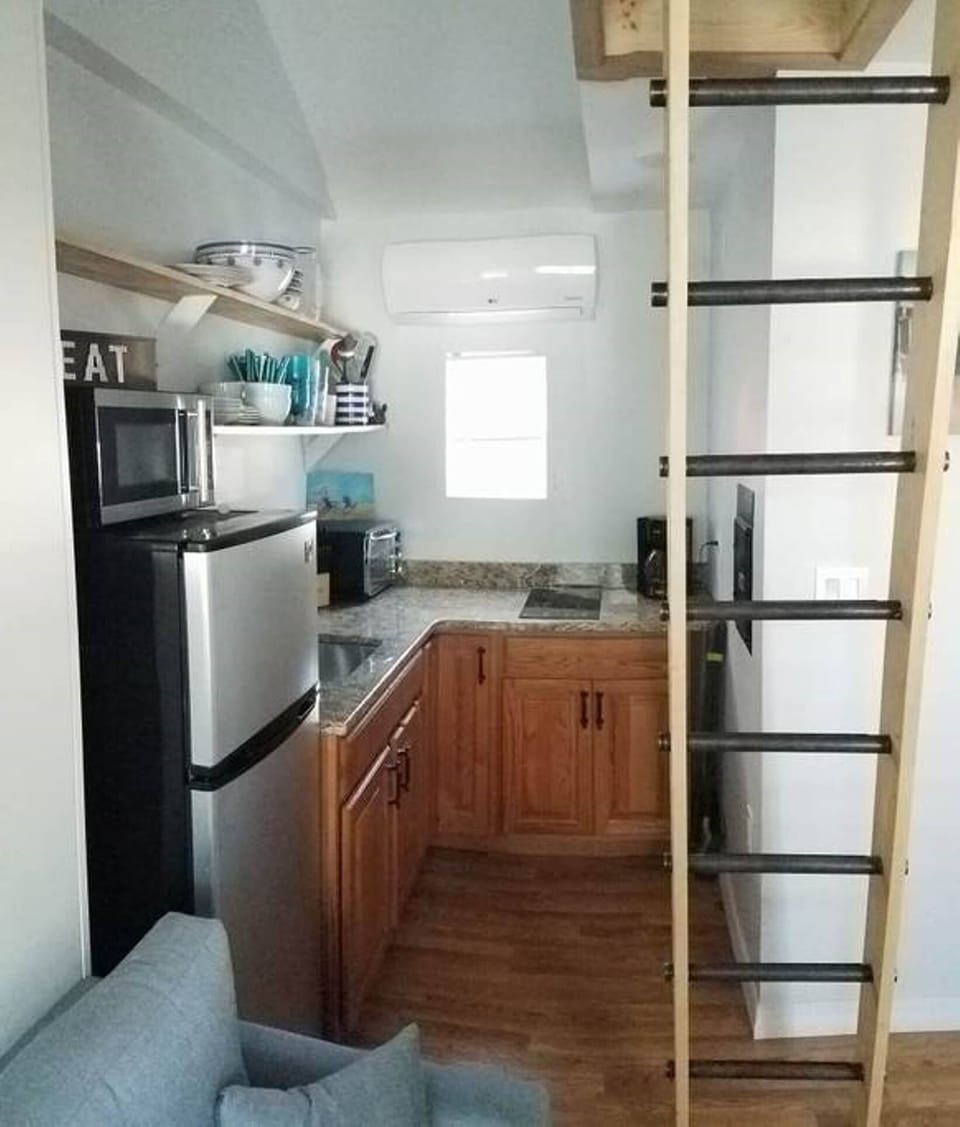 Kitchen with cook top, fridge, sink, and toaster oven. Modern HVAC. 
