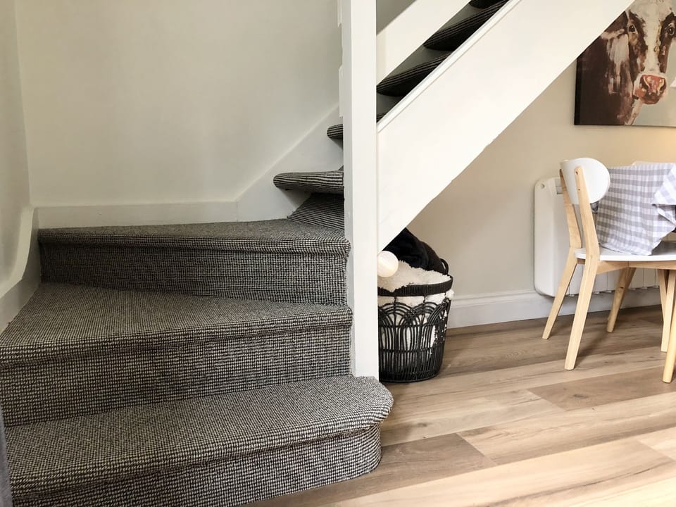 Carpet Stairs lead to both bedrooms & large bathroom