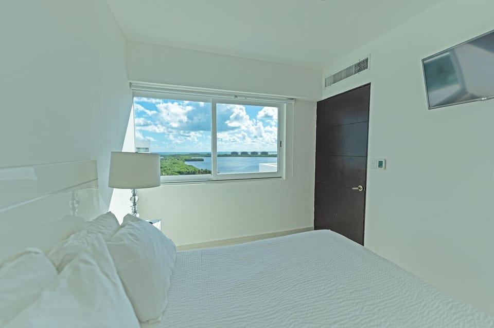 Bedroom 4 has a Queen Bed, attached Bathroom with Shower, and nice view of the Lagoon.