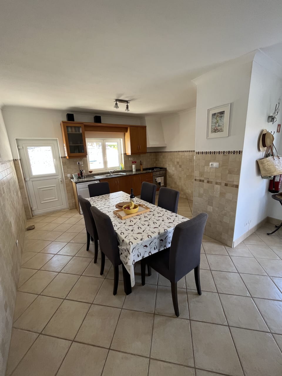 Kitchen with door to rear terrace and outside eating area 