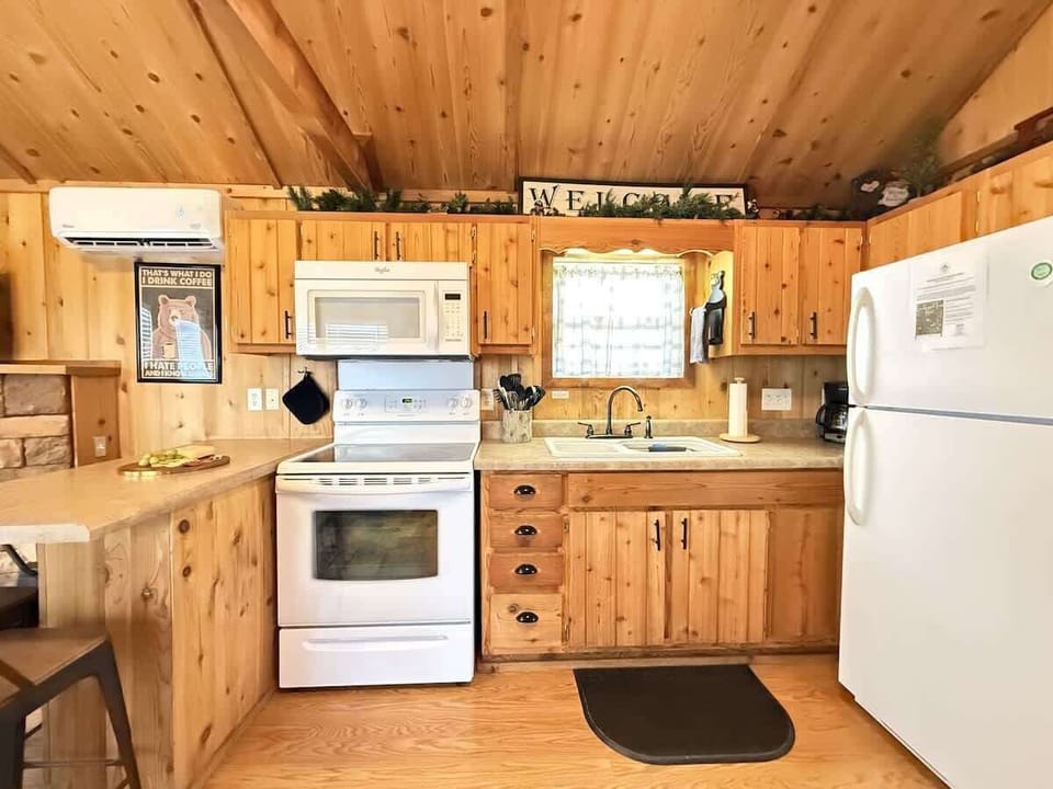 Full kitchen with appliances, cookware, dishes, silverware, and basic spices.