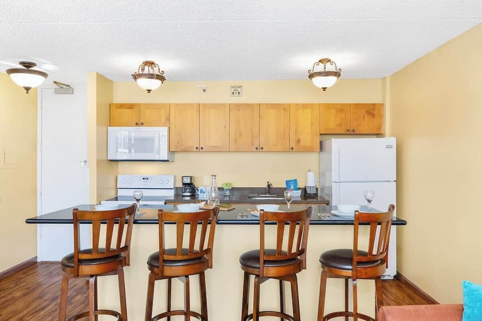 Fully equipped kitchen and kitchen counter with 4 bar stools.