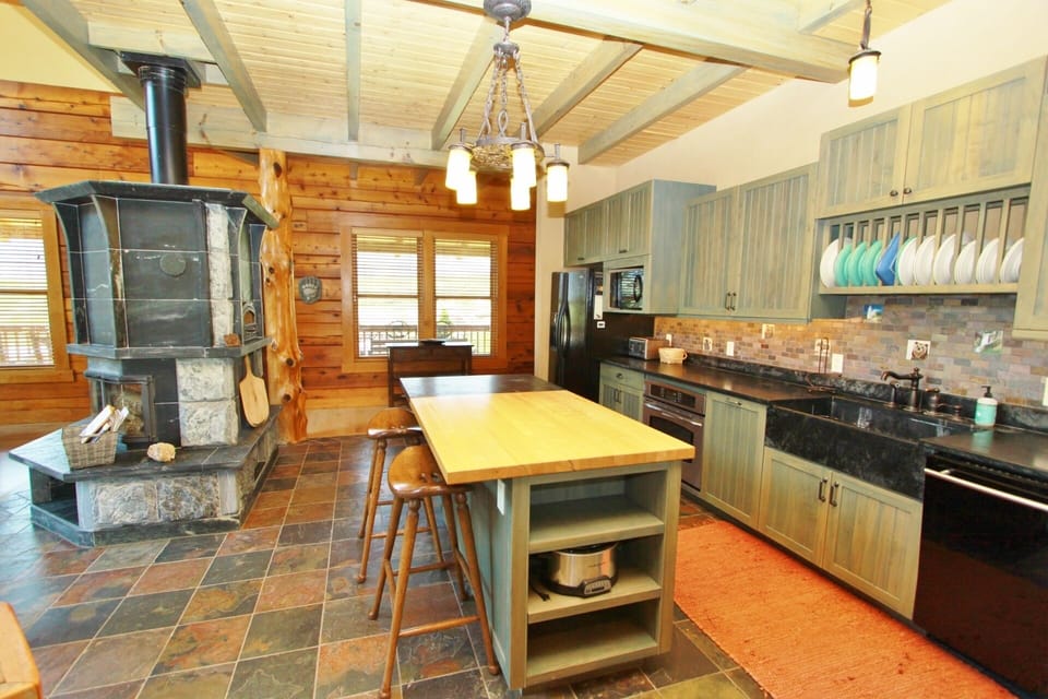 The kitchen has a central island and additional seating at the bar.