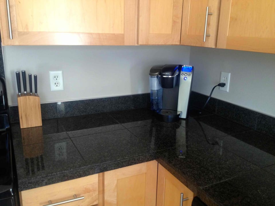 Fully equipped kitchen with coffeemaker, Keurig, cookware, and dishes