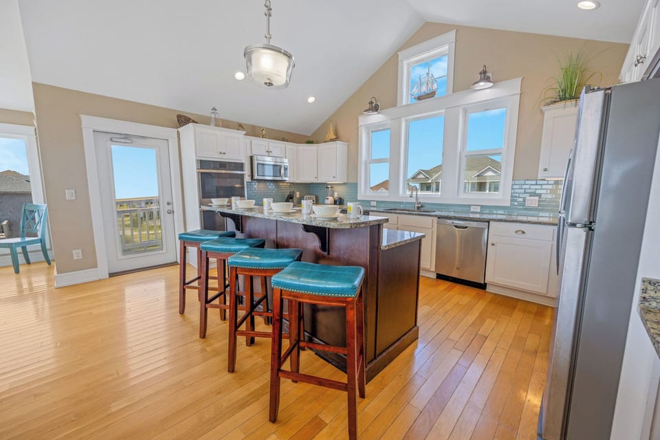 The chefs in the family are free to create culinary delights in the large open gourmet kitchen featuring granite countertops, custom cabinetry, two dishwashers, dual wall ovens and two full size refrigerators and a center island.