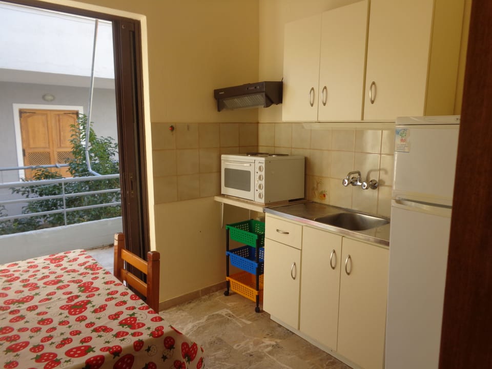 Apartment, 2 Bedrooms, Partial Sea View | Private kitchen | Full-size fridge, stovetop, electric kettle, cookware/dishes/utensils