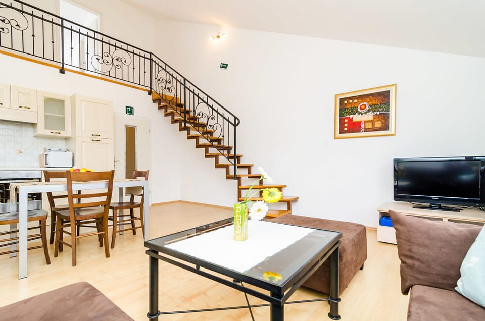 City Apartment, 1 Bedroom, Balcony (A2) | Living area | 82-cm flat-screen TV with satellite channels, TV