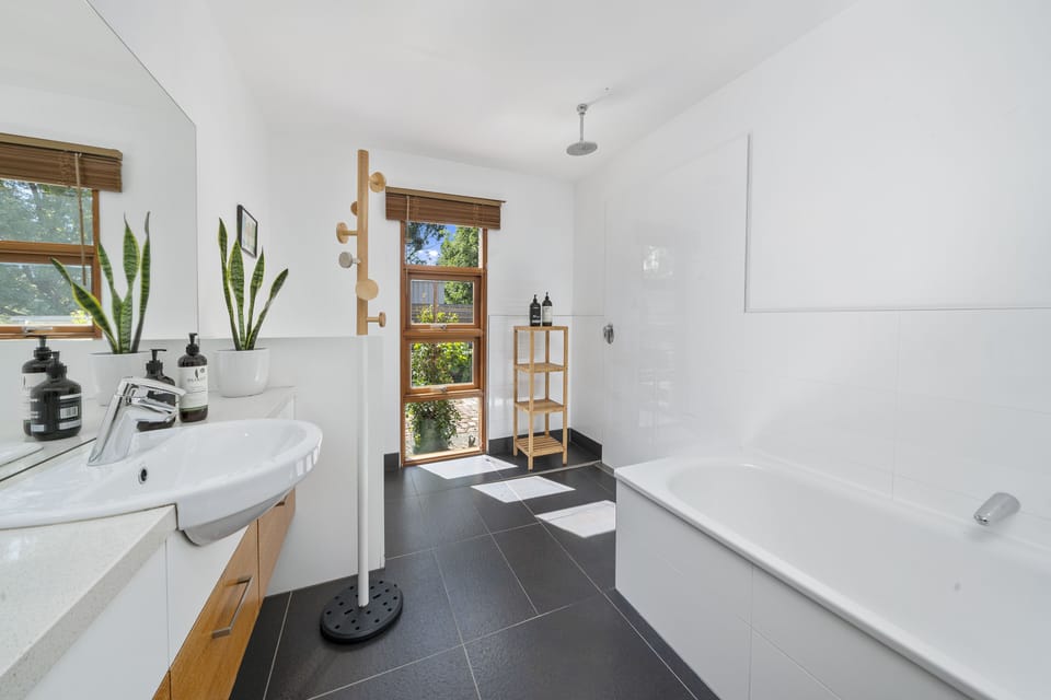 Master bathroom with full-size bath and open shower