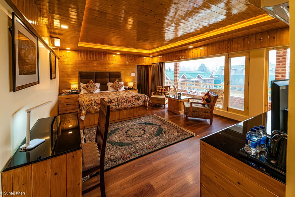 Luxury Premium Suite with Private Balcony | Living room | TV, foosball, table tennis, books