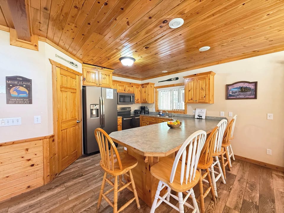 Fully equipped open kitchen with appliances, pots and pans, dishes, utensils, and basic cooking essentials.