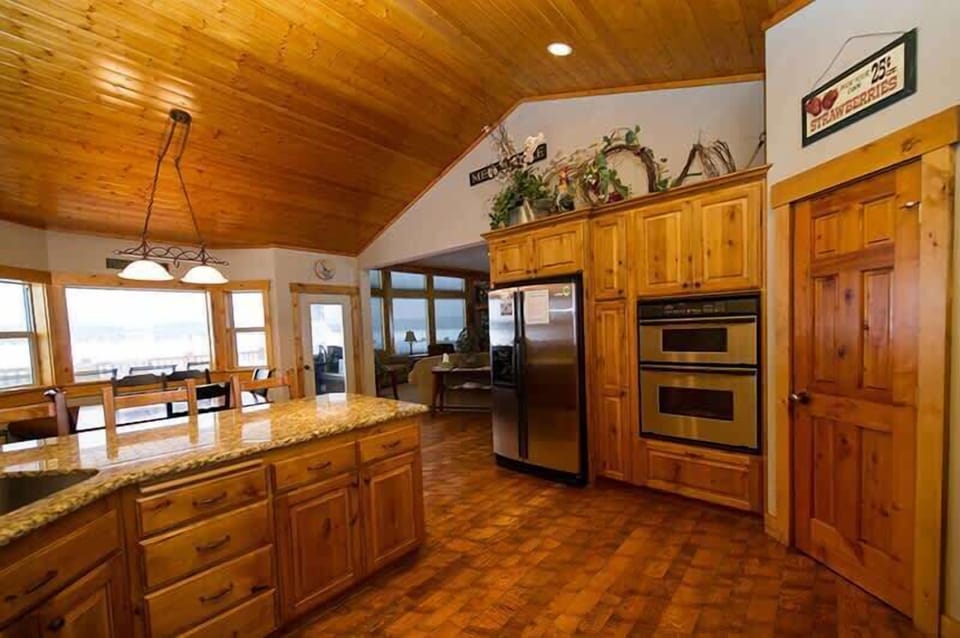 Kitchen equipped with stainless steel appliances, pots and pans, and basic cooking essentials.