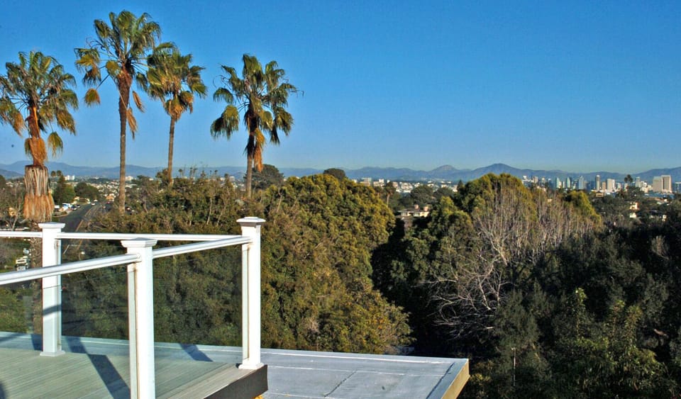view from roof top deck facing the city and mountains.