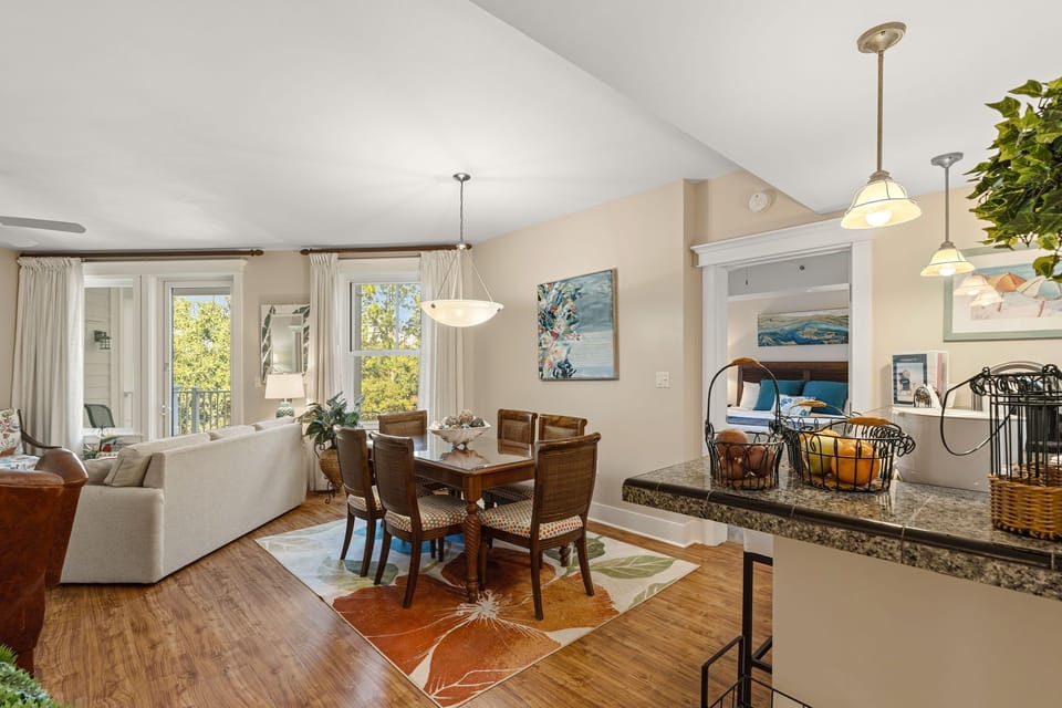 Entry view of living/dining area, bedroom on right, view of lanai & Grand Lawn 