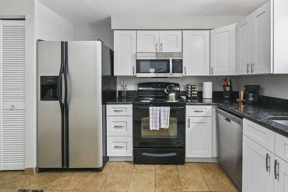 Kitchen cabinetry equipped with cooking & dining essentials