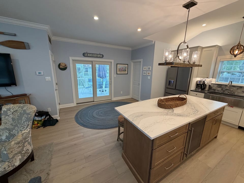 New larger kitchen with slider to the deck with powder room in the back corner.