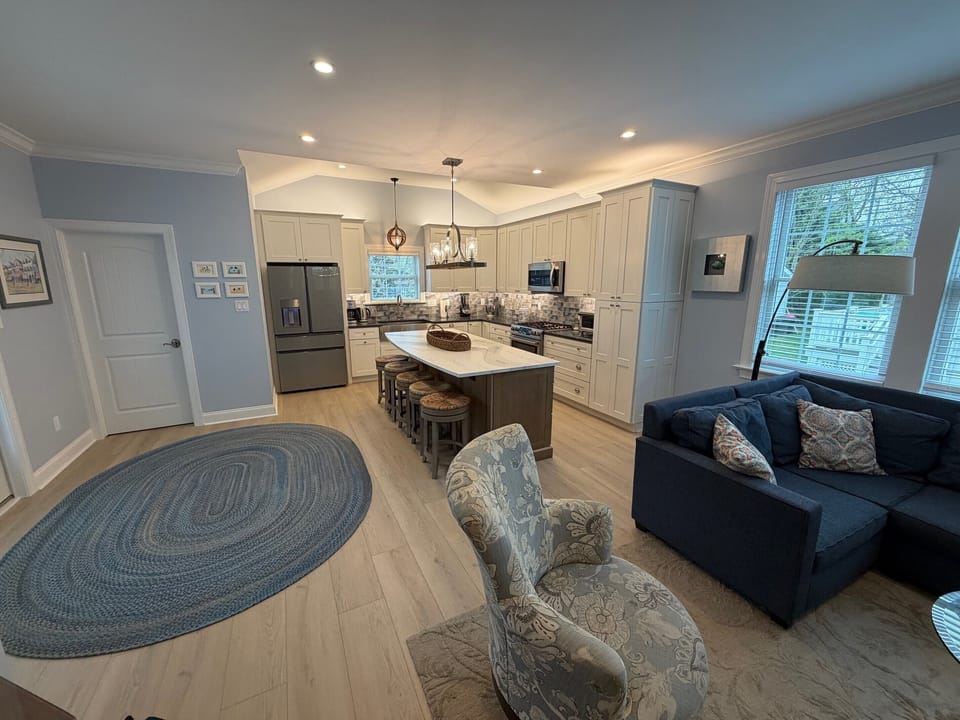 Living room and kitchen after addition.   The powder room is behind the door.