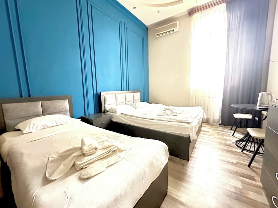 Family Quadruple Room | Living area | 32-inch TV with cable channels
