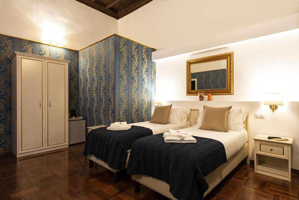 Triple Room, Private Bathroom | Minibar (free items), in-room safe, desk, blackout drapes