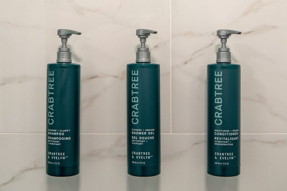 Bathtub, designer toiletries, hair dryer, towels
