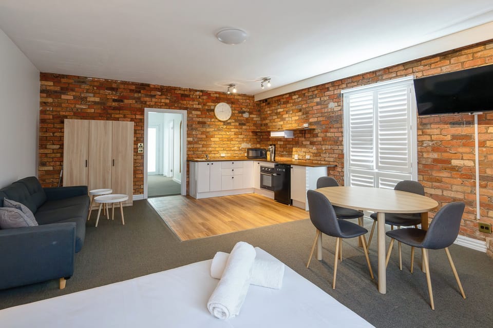 Standard Apartment | Desk, laptop workspace, blackout drapes, iron/ironing board