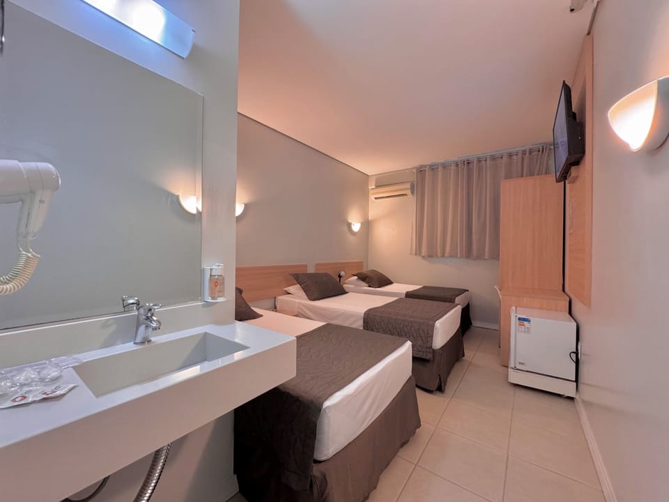 Executive Triple Room | Desk, laptop workspace, blackout drapes, free WiFi