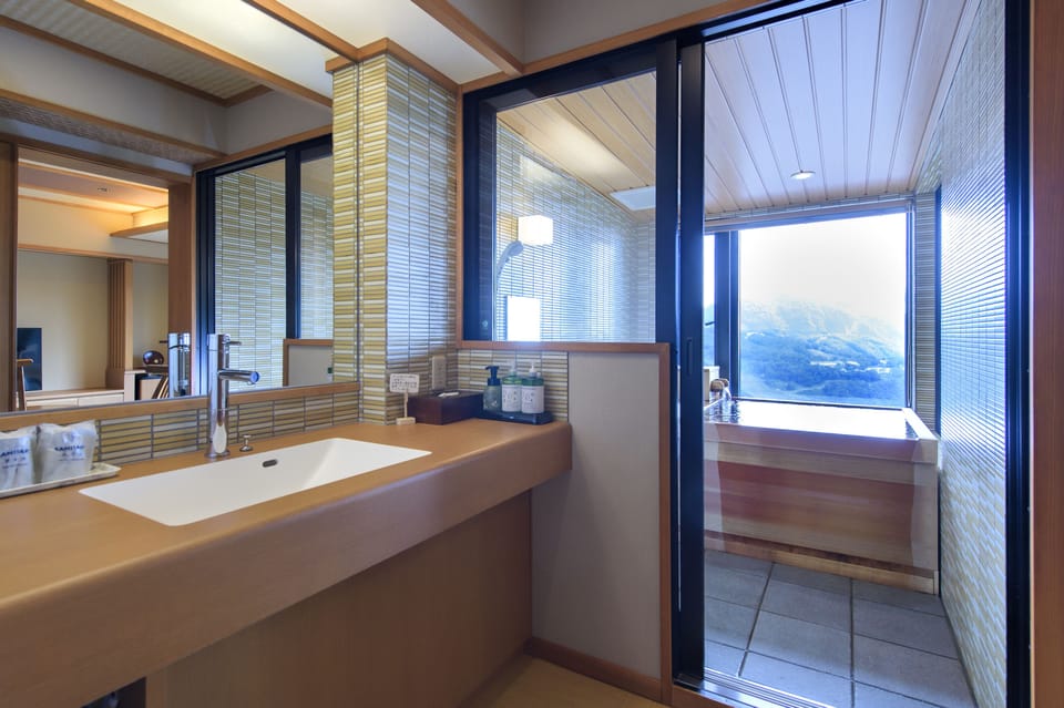 Deluxe Twin Room (with Private Open-air Bath, Seiho) | Bathroom | Free toiletries, hair dryer, slippers, electronic bidet