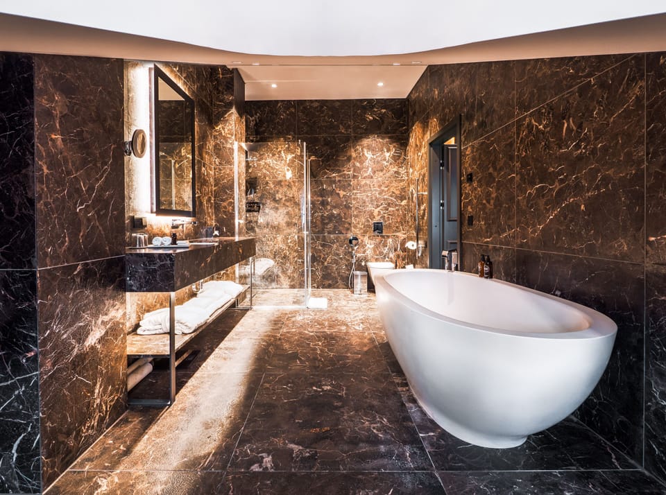 Junior Suite (Attic) | Bathroom | Designer toiletries, hair dryer, slippers, towels