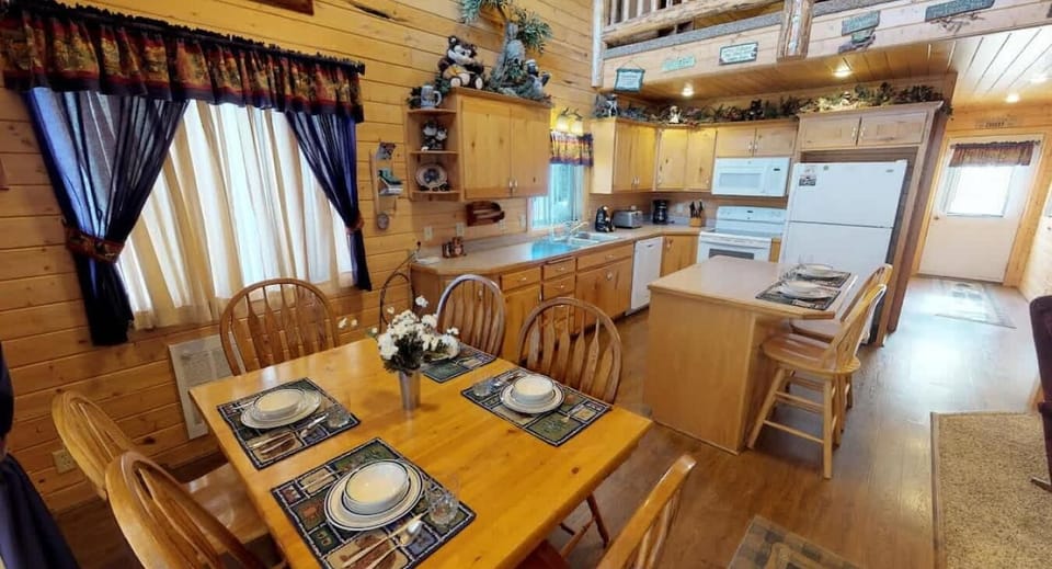 Upon entrance, you are greeted by the dining table and kitchen.