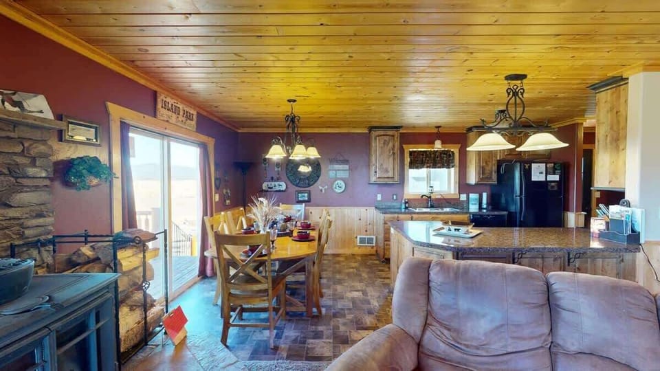 A large dining room table located next to the kitchen.