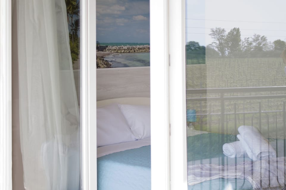 Double Room, Balcony, Partial Lake View | Minibar, in-room safe, individually decorated, desk