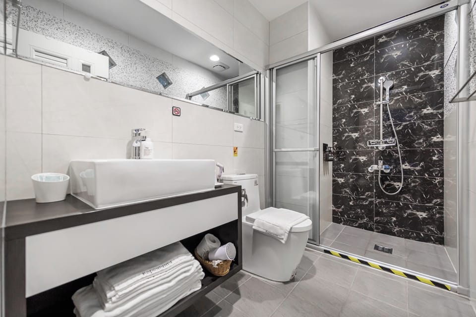 Shower, hair dryer, slippers, towels