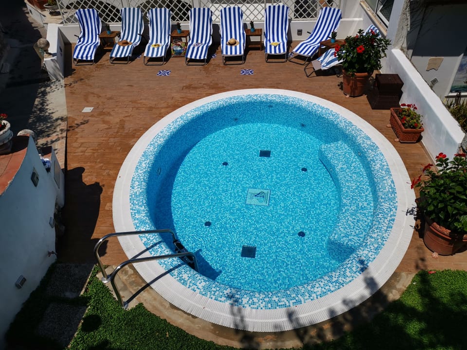 Seasonal outdoor pool, open 11:00 AM to 6:00 PM, sun loungers