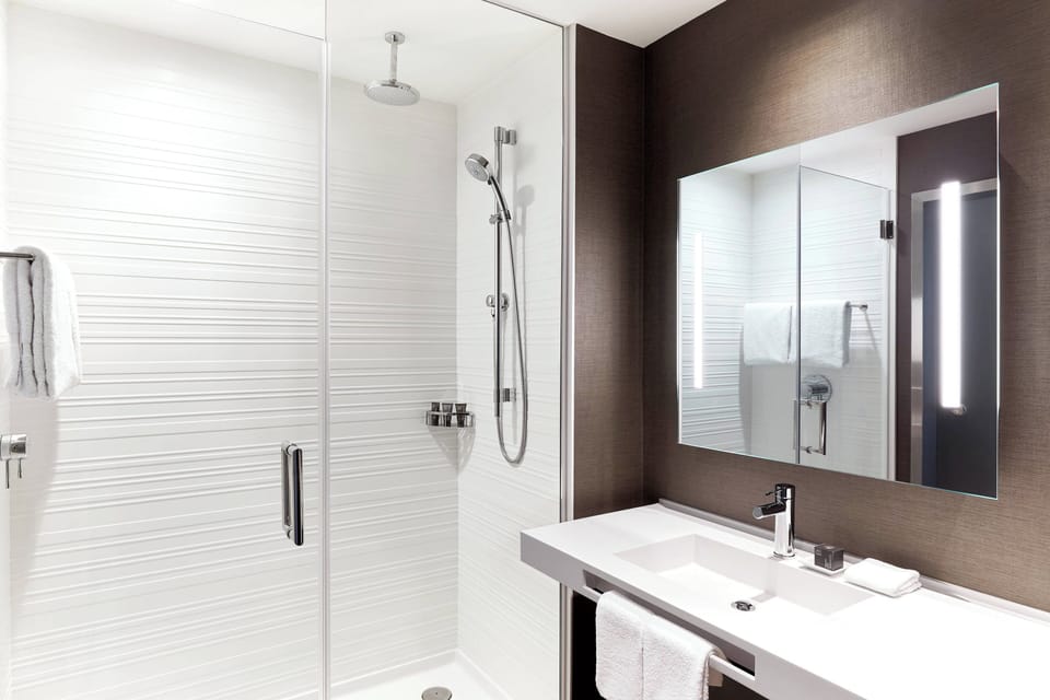 Shower, rainfall showerhead, designer toiletries, hair dryer