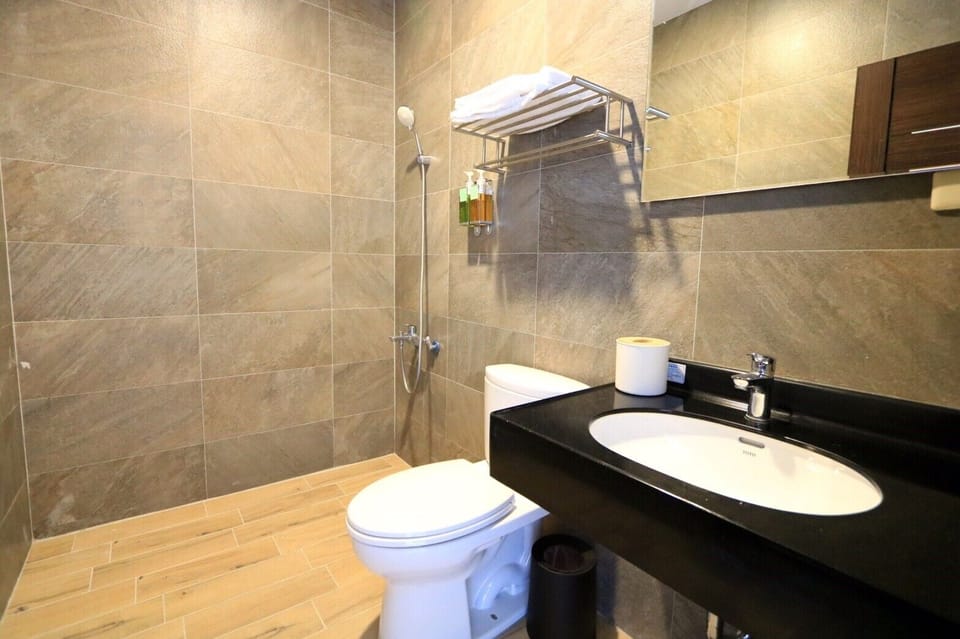 Shower, hair dryer, slippers, towels