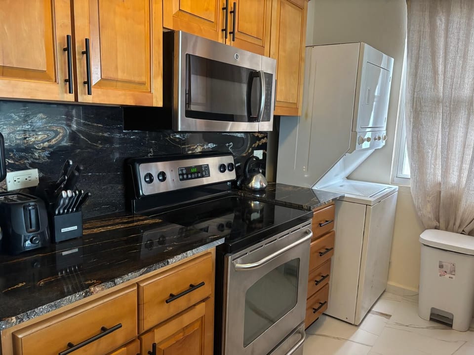 granite counter tops and stacked washer dryer
