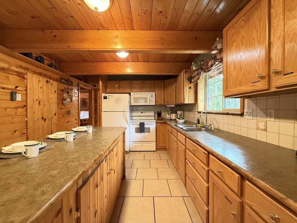 Full size kitchen with appliances, cookware, pots and pans, utensils, dishes, and basic cooking essentials.