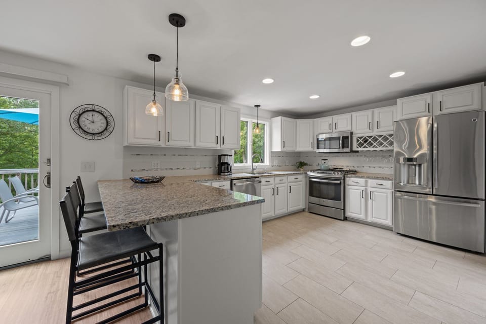 Large updated kitchen fully equipped, sliding glass door leading to deck