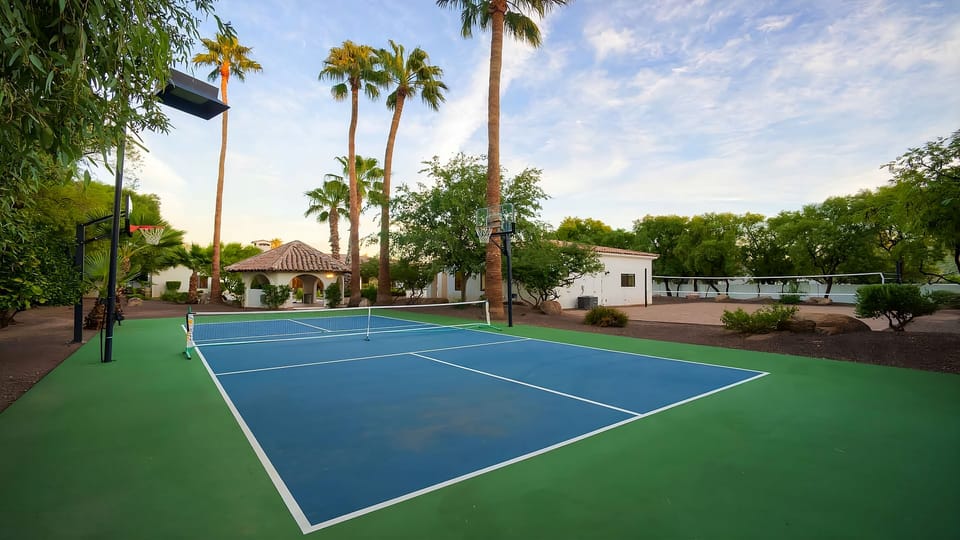 Beautiful sports court for basketball & pickleball surrounded by greenery