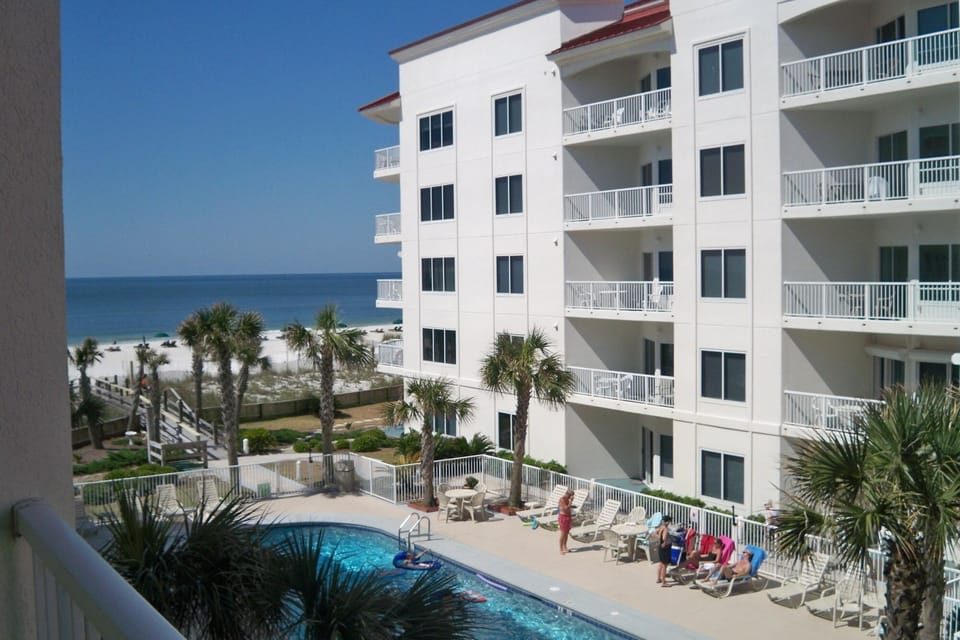 A view from the balcony to the Pool and Beach