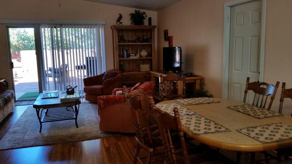 Dining and living room facing glass doors to yard. Dining table seats 6 people.