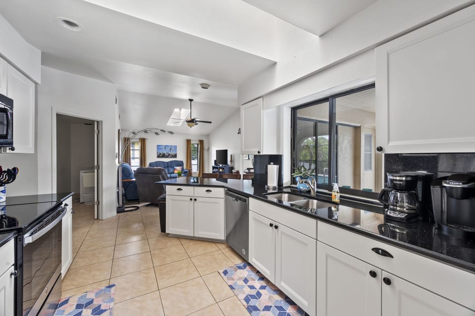 New well stocked kitchen with skylights and view to family room and laundry. 