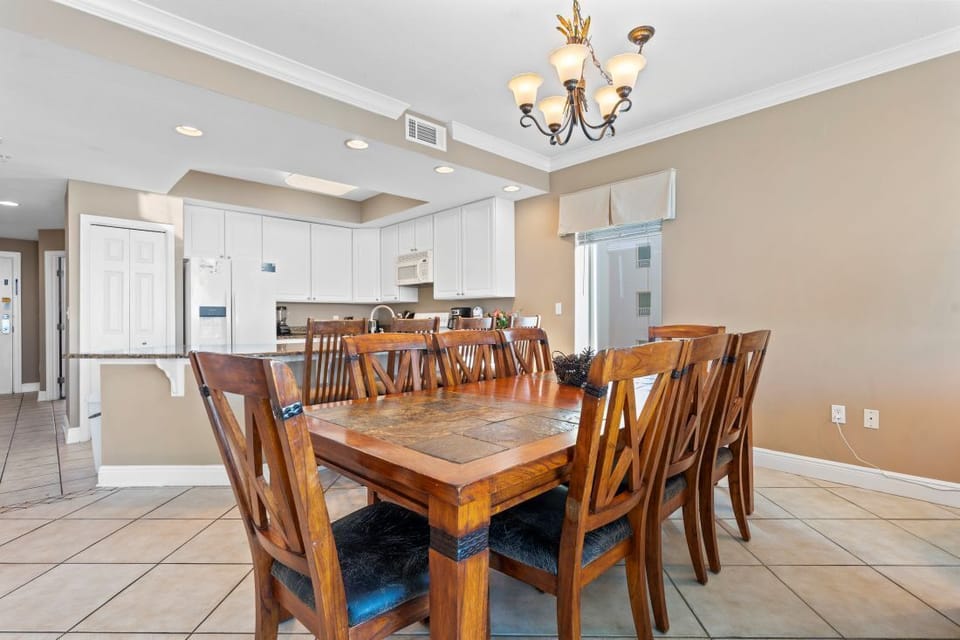 Gather around this elegant dining table where your group can share memorable meals together in this open, beautifully appointed space.