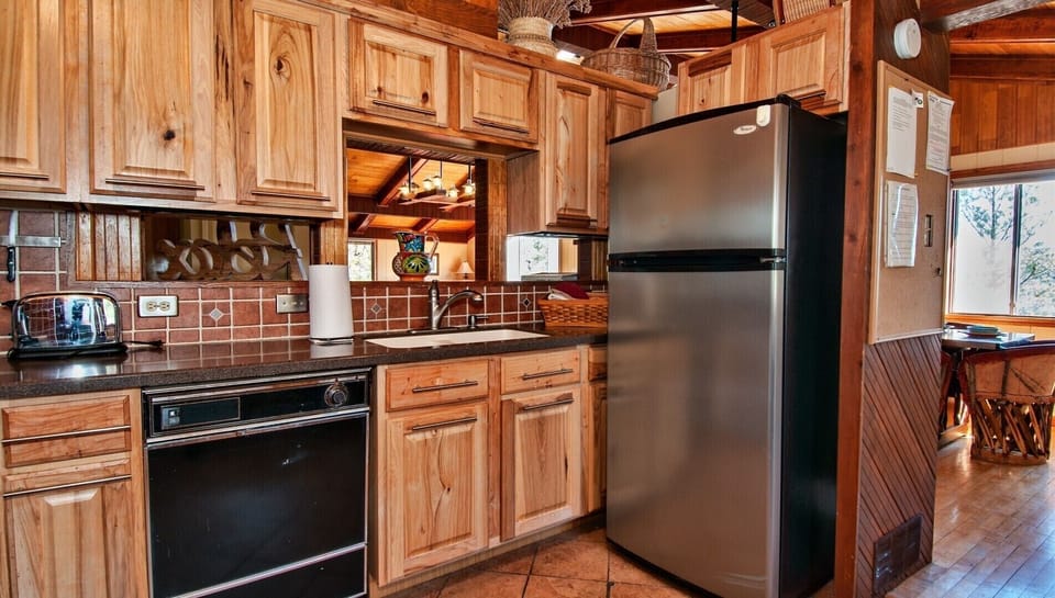 Ample storage, dishwasher, fridge and view into living room from the sink