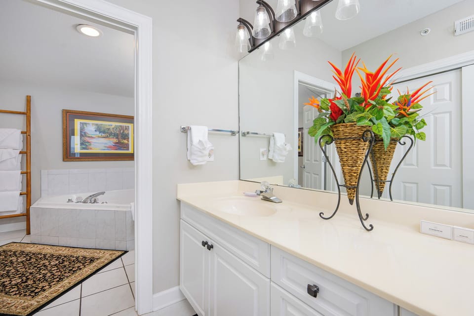 Fresh flowers brighten the master bath where you unwind beside the roomy jetted tub after a day outdoors