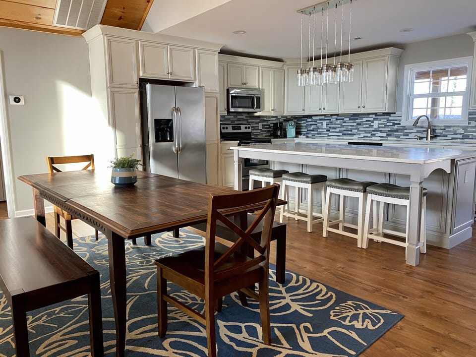 Dining area and fully stocked kitchen. Lots of seating at oversized island.
