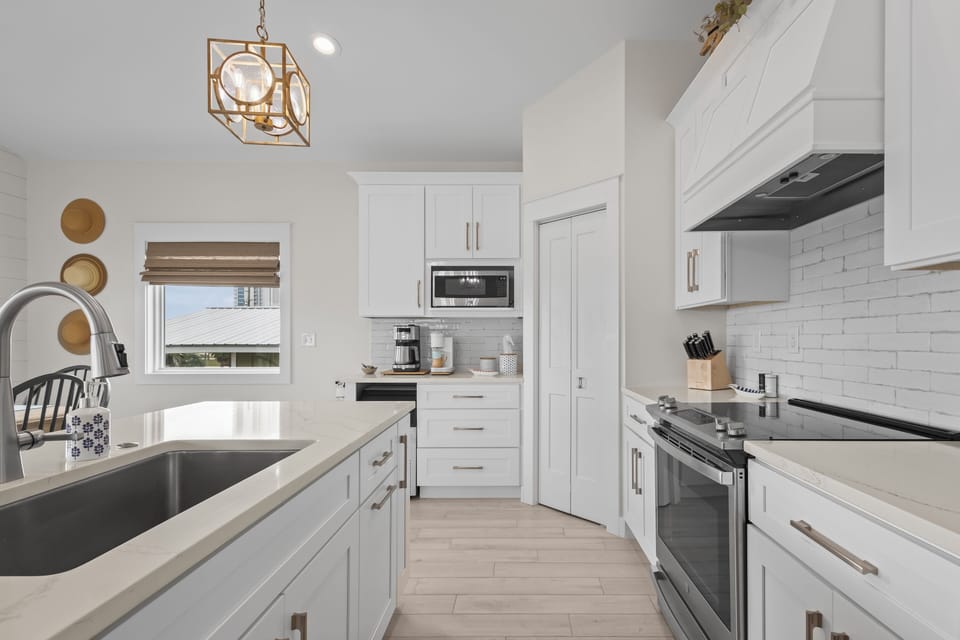 Large stainless steel sink, electric stove.
